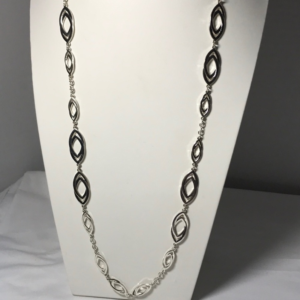 Charming Charlie necklace in silver tone measuring 33 total in, oval stations